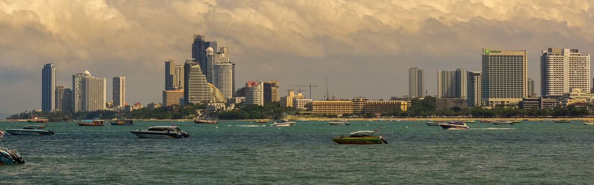 Sunset over Pattaya’s coastal city on a vibrant Pattaya Travel guide banner by Legend Travel Group.